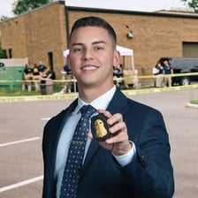 An FBI agent represented by a badge and formal attire.