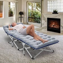 A portable folding cot with a fabric sleeping surface