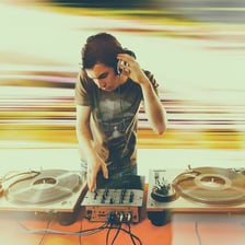 A DJ mixing music in a nightclub.