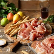 Slices of cured ham arranged on a serving board.