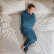 A person comfortably tucked tightly beneath a blanket.