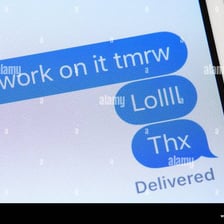 A smartphone displaying a text message containing “LOL.”