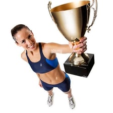 A winning athlete holding a championship trophy.