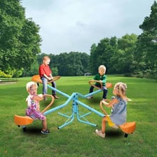 Children riding a seesaw on a playground