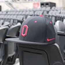 A baseball cap displayed on a baseball field.