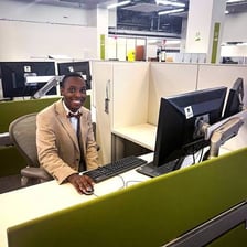 A student intern working at an office desk