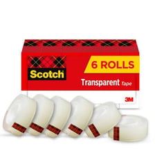 A roll and strip of clear adhesive tape among school supplies.