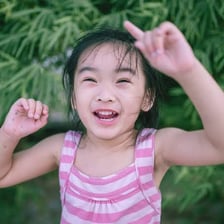 A portrait of a young girl outdoors.