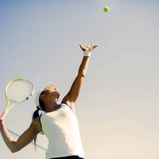 A tennis player delivering a powerful serve