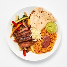 A plate of Tex-Mex food including tacos and fajitas