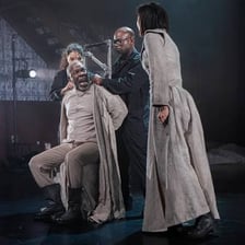 An actor performing on a theater stage.