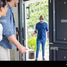 A smiling host welcoming a guest