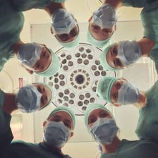 Doctors working together in a hospital operating room.