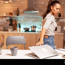 An office worker closing a laptop at the end of the workday