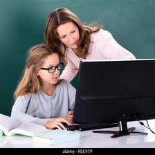 A tutor explaining a lesson to a student at a desk