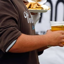 A person paying for a round of drinks at a bar