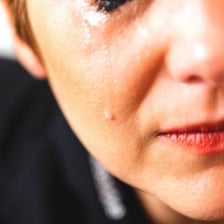A person crying during an emotional moment.
