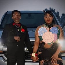 A formally dressed person attending a dance without a partner.