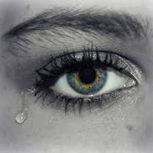 A person with visibly misty or teary eyes.