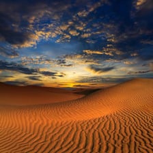 A large wind-shaped sand dune in a desert.