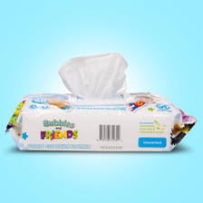 A moistened baby wipe beside its packaging