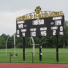 An American football scoreboard displaying touchdown scores.