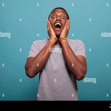 A person showing surprise with widened eyes and an open mouth.