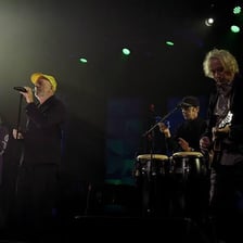The rock band R.E.M. performing onstage.