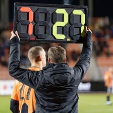 A substitute athlete entering a sports game from the bench.