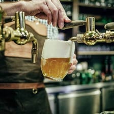 A beer tap mounted on a pub bar