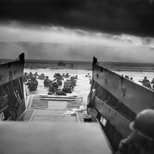 Allied troops landing on a Normandy beach during D-Day