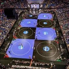 Wrestlers competing on a circular wrestling mat