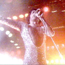 Queen performing “We Are the Champions” onstage.