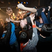 A crowd of concertgoers in a mosh pit