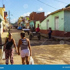 People talking together on a small-town street.
