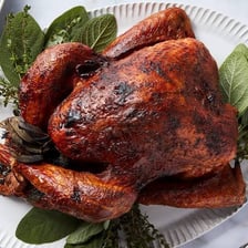 A whole turkey roasting in an oven.