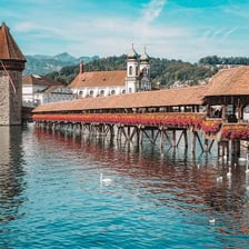 The covered wooden Chapel Bridge crossing the Reuss River in Lucerne