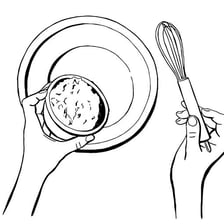 A hand adding an ingredient to a mixing bowl.