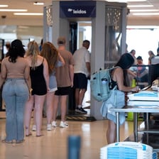 Passengers passing through an airport security checkpoint