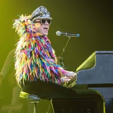 Singer Elton John performing at a piano
