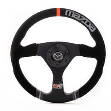 A driver holding and steering a car’s wheel