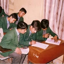 A student writing an answer on a worksheet.