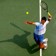 A tennis player hitting a powerful serve