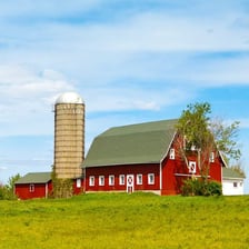 A tall grain silo standing on a farm.