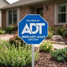 An ADT home-security sign displayed outside a house