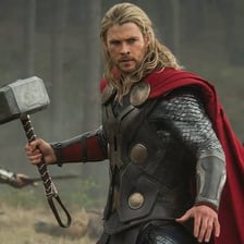 Thor holding his hammer in an Avengers scene.