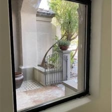 A rectangular pane of glass fitted into a window frame