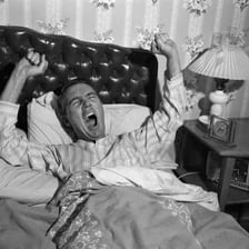 A person getting out of bed in the morning.