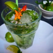 Fresh mint leaves garnish a glass of mojito.
