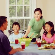 People beginning a meal at a dining table